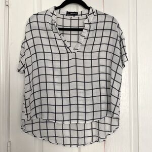 This is a SHEIN large white blouse with black square lines.